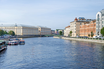 Fototapeta premium Fontanka river embankment, the English Bridge and tourist boats in St.Petersburg, Russia