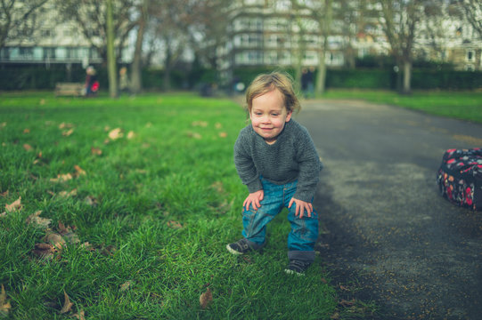 Little toddler on the grass in a park