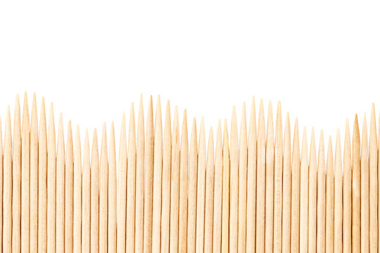 Bamboo toothpicks are placed in parallel - backgrounds, textures. Bamboo toothpicks isolated on white background