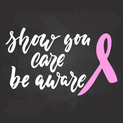 Show you care be aware - hand drawn October Breast Cancer Awareness Month lettering phrase on black chalkboard background. Brush ink vector quote for banners, greeting card, poster design.