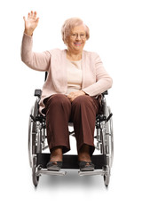 Elderly disabled woman sitting in a wheelchair and waving