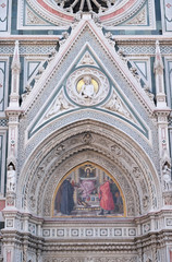 Fototapeta na wymiar Charity among the founders of Florentine philanthropic institutions, Left Portal of Cattedrale di Santa Maria del Fiore, Florence, Italy 
