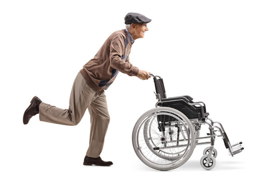 Ederly man running and pushing an empty wheelchair