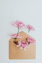  Love concept. Craft envelope full of flowers. Flat lay.