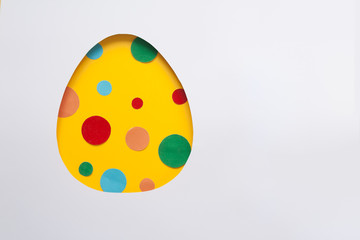 Easter egg made of paper with cut balls on white background. Cut from paper.
