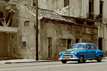 Street scene with vintage car in old town Havana