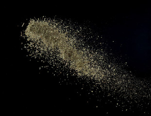 Fototapeta na wymiar Oregano spice splash or explosion flying in the air isolated on black background,Motion blur
