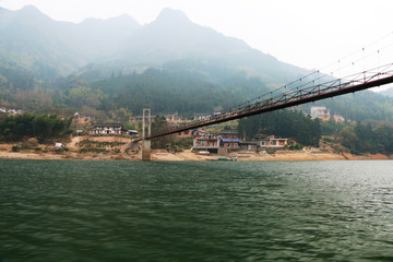 A suspension bridge in the mountains of China in winter
