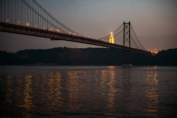 Fototapeta na wymiar 25 april bridge landscape and Christ the King in Lisbon, Portugal