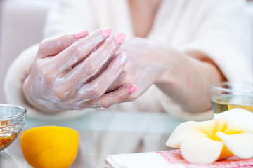 Obraz na płótnie Canvas Woman applying the cream on hands moisturizing and nourishing them with natural cosmetics. Hygiene and care for the skin