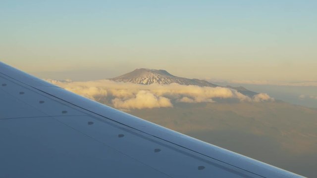 Flying over Mount Etna. Mount Etna is an active stratovolcano on the east coast of Sicily, Italy, in the Province of Catania, between Messina and Catania. It is the largest active volcano in Europe.