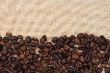 Fototapeta premium Coffee beans on the textile and copy space