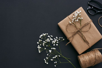 Design your gift! Beautiful gift box in kraft brown paper on dark background