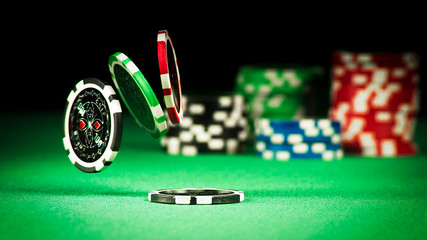 Gambling concept, scattered chips on a green gown - obrazy, fototapety, plakaty