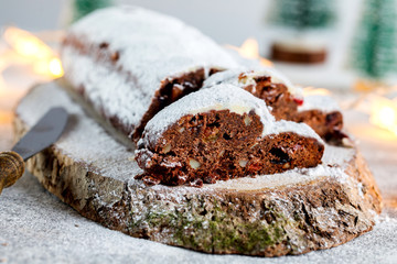 Christmas or New Year pastries Holidays Concept Dresdnen Stollen Chocolate Traditional German Cake Gift Fruit Cake Holiday , European festive dessert Decoration selective focus