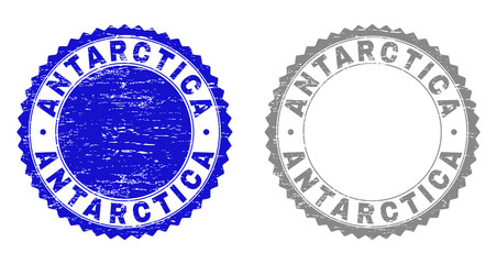 Grunge ANTARCTICA stamp seals isolated on a white background. Rosette seals with grunge texture in blue and grey colors. Vector rubber watermark of ANTARCTICA label inside round rosette.
