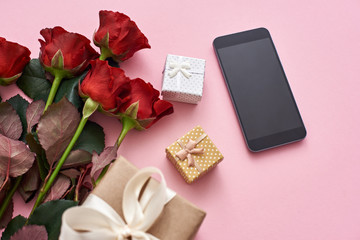 Obraz na płótnie Canvas Application love. Impress her with fresh red roses, gift box and black cellphone
