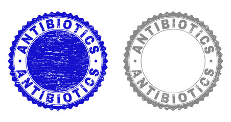 Grunge ANTIBIOTICS stamp seals isolated on a white background. Rosette seals with grunge texture in blue and grey colors. Vector rubber overlay of ANTIBIOTICS label inside round rosette.