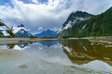 reflections of mountains in the water, milford sound, new zealand 6