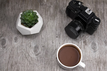 top view camera, succulent in concretepot and hot coffee cup on a gray wood