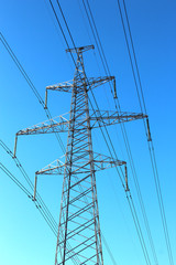 Power transmission tower on background of blue sky