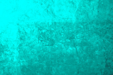 Old concrete wall sloppy painted turquoise