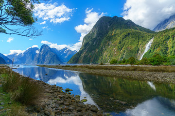 reflections of mountains and a waterfall, milford sound, new zealand 2