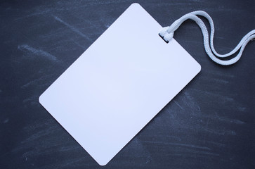 Badge blank plastic empty security. Name id card badge with cord on black background, empty space for text.