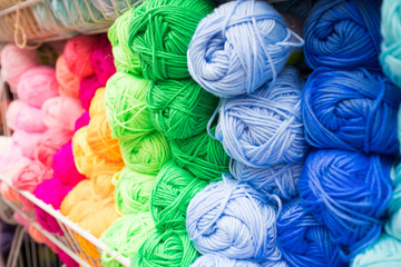 Fototapeta na wymiar Coloured wool yarn into skeins and tangles. Bright yarn for knitting.