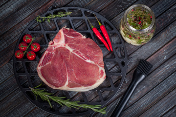  beautiful and juicy raw steak on the table with ingredients ready to roast