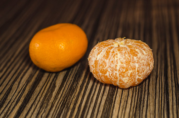 Two mandarins on the wooden table