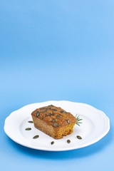 Gluten-Free pumpkin bread with pumpkin seed in white plate.