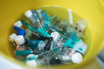 needles and syringes in disinfectant. disposal of medical needles and syringes and medical waste