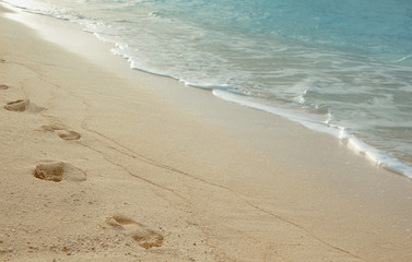 Human footprints on a sandy beach.
