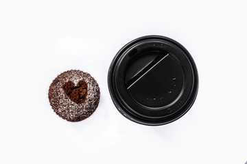coffee to go and muffin with heart isolated on white background, top view