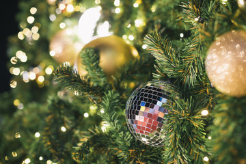 Christmas disco ball decorating on branch fir of Christmas tree and Christmas ornament.