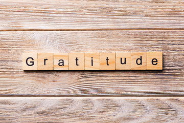 gratitude word written on wood block. gratitude text on wooden table for your desing, concept