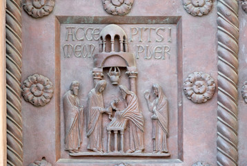 Presentation of Jesus in the Temple on the San Ranieri gate of the Cathedral St. Mary of the Assumption in Pisa, Italy 