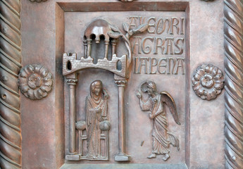 Annunciation of the Virgin Mary on the San Ranieri gate of the Cathedral St. Mary of the Assumption in Pisa, Italy 