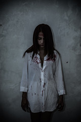 Close up woman wear white shirt in the dark room,Scary movie concept,Horror background,Thailand...