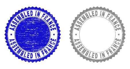 Grunge ASSEMBLED IN FRANCE stamp seals isolated on a white background. Rosette seals with grunge texture in blue and gray colors.