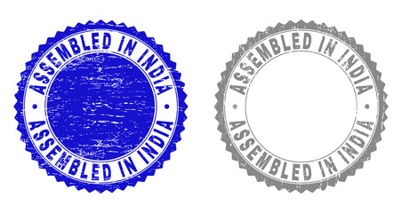 Grunge ASSEMBLED IN INDIA stamp seals isolated on a white background. Rosette seals with distress texture in blue and grey colors.
