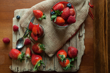 Low Carb Strawberry and chia puddings in a glass, wood background