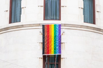 Rainbow gay pride flag on the pastel wall