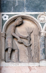 June, detail of the bas-relief representing the Labor of the months of the year, portal of the Cathedral of St Martin in Lucca, Italy
