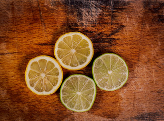 lemon slices of lime on wooden background