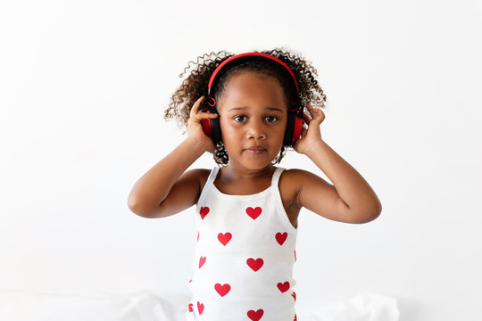 Girl wearing headphones and heart tank top