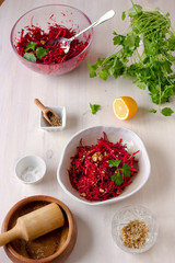 Healthy raw vegan beetroot salad with carrot and walnuts in a bowl on white wooden table. Natural organic food concept. Healthy diet