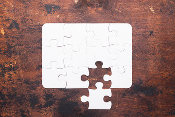 Jigsaw Puzzle with missing piece on old wooden background