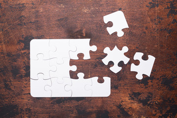 Jigsaw Puzzle with missing piece on old wooden background